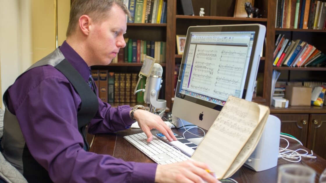 PCG music director Ryan Malone notates "Spread It Before the Lord" from The Book of Isaiah. (Photo: Matthew Friesen)