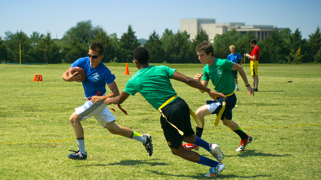 Michael (6B) runs for a down while Gianni and Jesse attempt to pull his flag. 