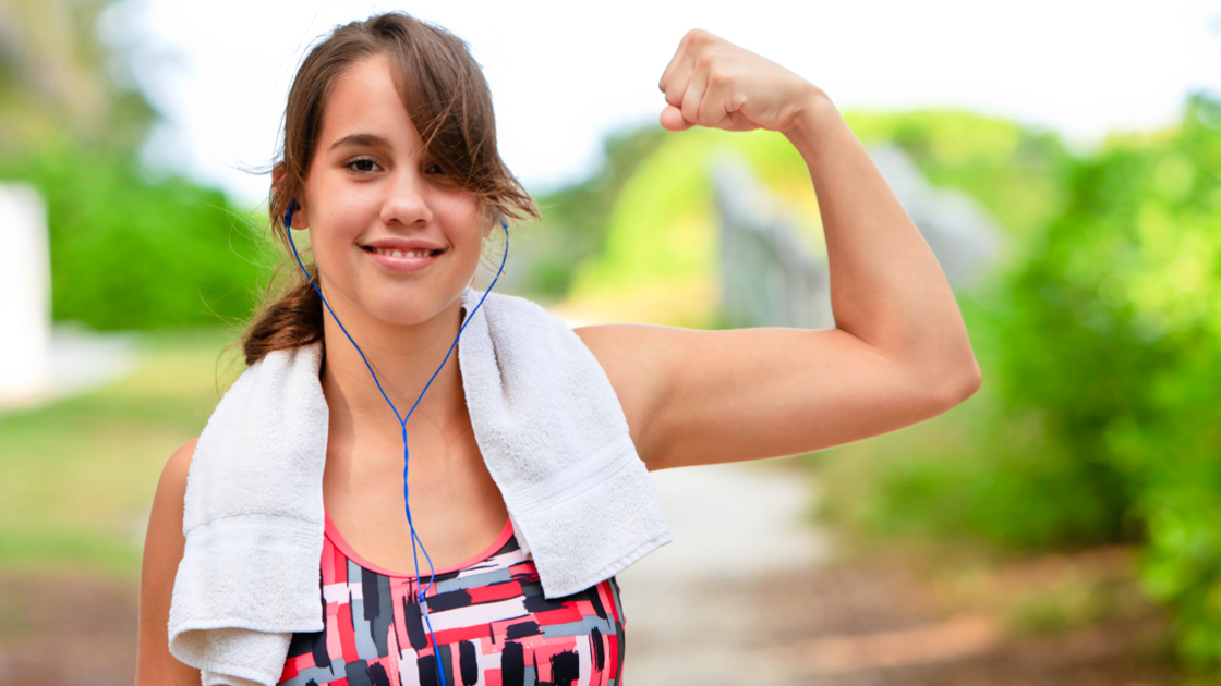 16x9(One bad reason to exercise)
Smiling teenage female wearing sports clothing, towel around neck, and earphones flexing bicep