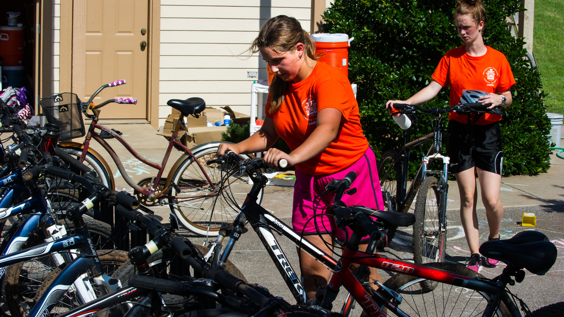 A member of dorm 1G puts up her bike after a run on the cycling long course