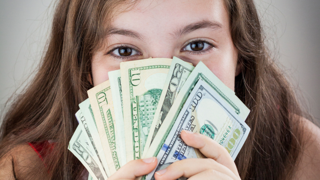 16x9(God's Tithing Challenge)
Beautiful teen girl holding money cavering her face