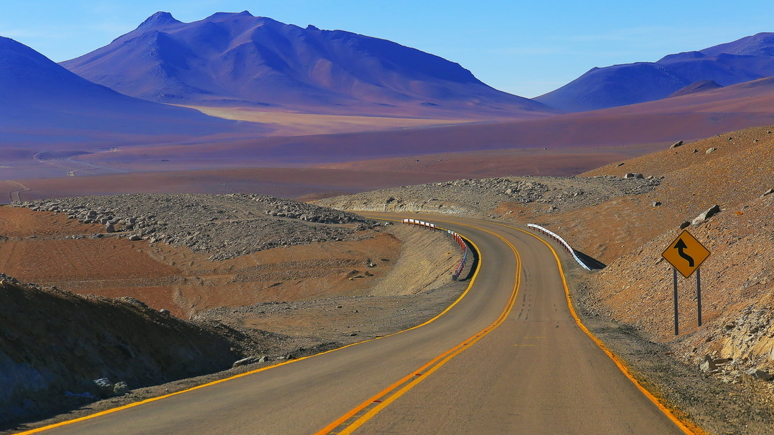 Highway asphalt Road to Atacama Desert  – dramatic volcanic landscape –  Chile