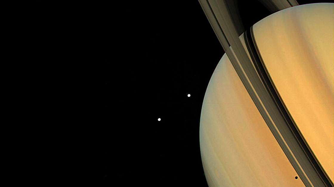 Saturn. Moons Tethys and Dione. Shadows of its rings and moons on Saturn. Taken by Voyager 1 (1980)