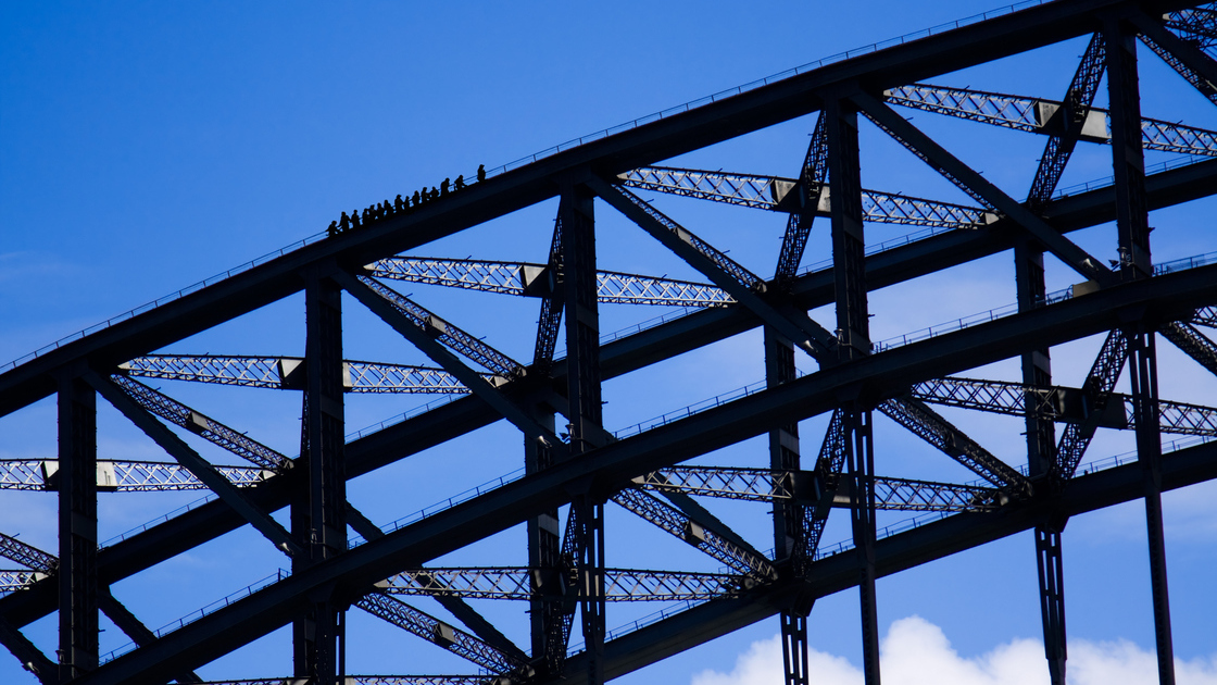 MEM SHB Sydney Harbour Bridge climbers silhouetted against a blue sky 3