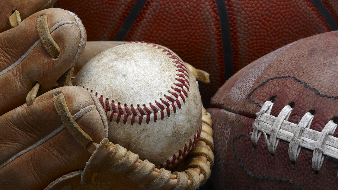 close up shot of well worn baseball in baseball glove, football and basketball So you want to go to PYC 16x9